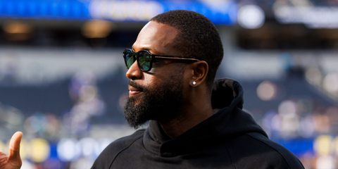 Dwyane Wade was seen wearing black Prada PR A16S 16K04D sunglasses with green polarised lenses at SoFI Stadium, January 2025. Shop online now on Pretavoir