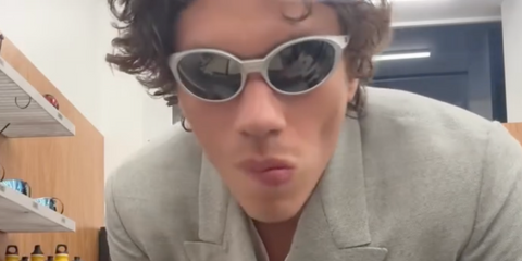 Actor Elias Becker was seen wearing grey silver Oakley Eye Jacket Redux OO9438 05 Prizm Polarised oval sunglasses in his Instagram post, January 2025.