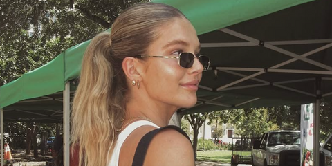Model Ellie Thumann was seen wearing gold Gucci GG1457S 001 rectangular sunglasses with grey lenses in her Instagram post, September 2023.