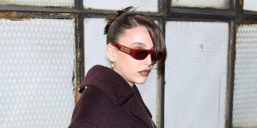 Emma Chamberlain wears Gucci GG1771S 003 sunglasses in red, to the brand's Fall/Winter 2024 fashion show in Milan