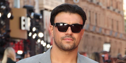 Ercan Ramadan was seen wearing black Prada PR A06S 16K08Z square sunglasses at the European premiere of The Devil Wears Prada 2 in London, April 2026.