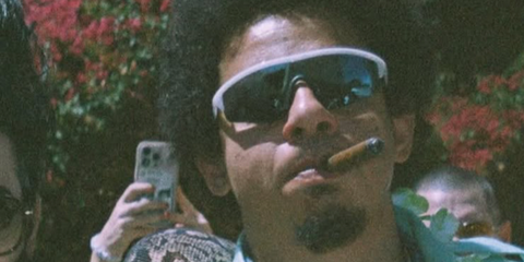 Actor and comedian Eric André was seen wearing white Oliver Peoples R-7 OV5560S 7007/55 sunglasses with blue flash mirror lenses in her Instagram post, April 2026.