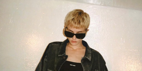 Model and actress Esther McGregor was seen wearing black Miu Miu MU 09WS 1AB5S0 in a campaign directed by Tyrone LeBon, January 2023. Shop online now on Pretavoir