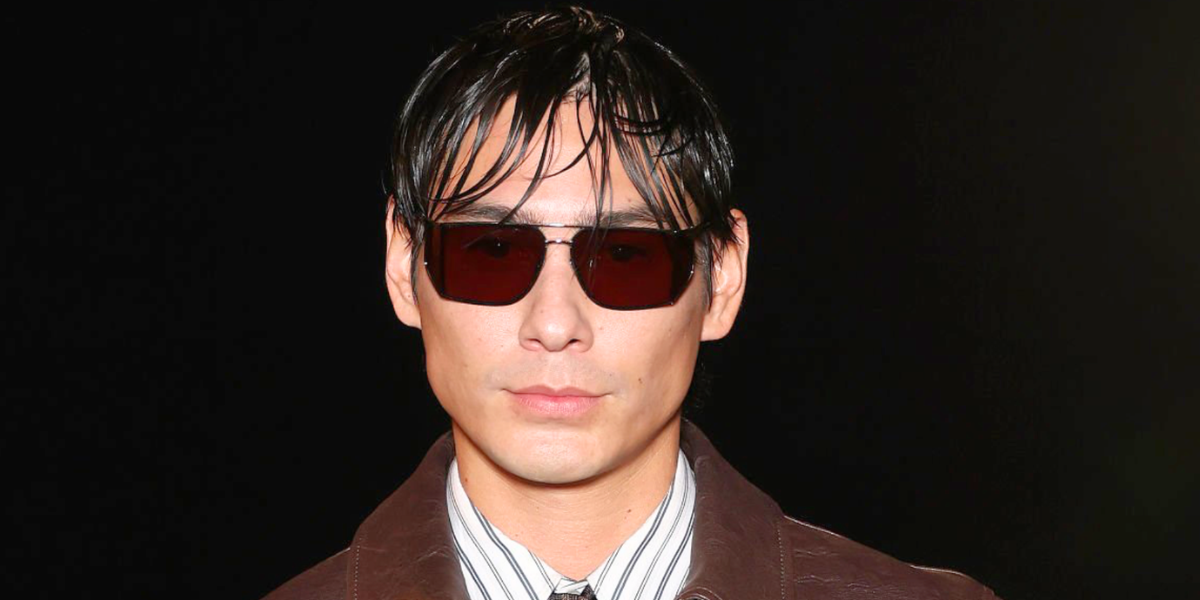 Evan Mock wore silver Saint Laurent SL 750 003 sunglasses with brown lenses at the Saint Laurent Spring Summer 2027 show during Paris Fashion Week.