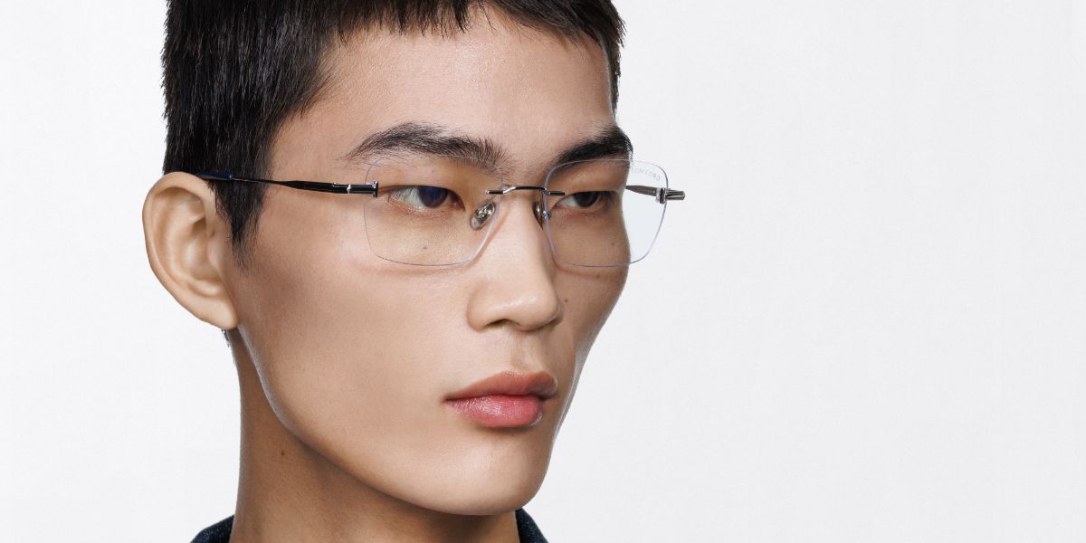Male model wears Tom Ford TF6117-B 016 Blue Control rimless optical glasses