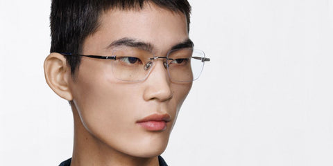 Male model wears Tom Ford TF6117-B 016 Blue Control rimless optical glasses