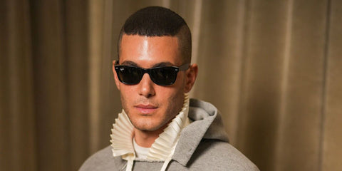 Fai Khadra was seen wearing black Ray-Ban New Wayfarer RB 2132 901L sunglasses at the Dior Menswear Fall/Winter 2026 fashion show during Paris Men's Fashion Week.