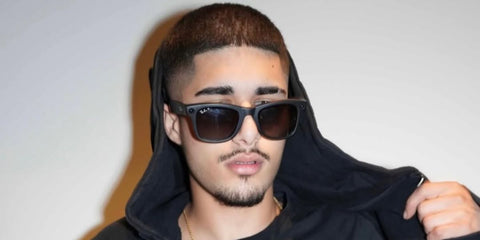 Rapper Fakemink was seen wearing matte black Ray-Ban Meta Wayfarer Gen 2 RW4012 601S/T3 Polarised Smart Glasses in UndergroundSound's Instagram post, October 2025.