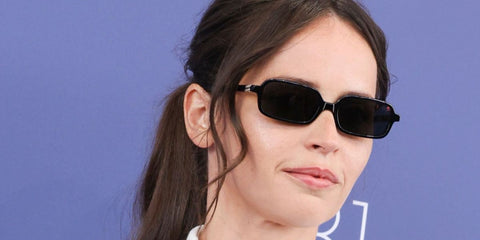 Felicity Jones was seen wearing black Miu Miu Regard MU 11ZS 16K5S0 rectangular sunglasses at the Venice Film Festival 2025. Shop online now on Pretavoir