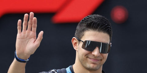 Esteban Ocon waving to fans during the 2024 F1 season with Alpine wearing his OAKLEY Sutro Ti OO6013 01