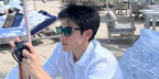Thai actor Fourth Nattawat was seen wearing black Miu Miu MU A05S 16K08Z sunglasses with grey lenses in Dubai, February 2025. Shop online now on Pretavoir