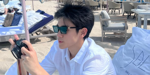 Thai actor Fourth Nattawat was seen wearing black Miu Miu MU A05S 16K08Z sunglasses with grey lenses in Dubai, February 2025. Shop online now on Pretavoir