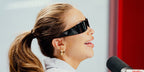 Gabby Windey was seen wearing black Prada PR A14S 1AB5S0 wraparound sunglasses while taping for iHeart Radio podcast Las Culturistas, April 2025
