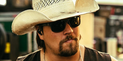 American country musician Gavin Adcock was seen wearing matte black Oakley Holbrook XL OO9417 05 sunglasses with prizm black lenses in his Facebook post, October 2025.