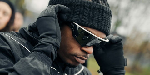 Gunna was seen wearing white Oakley Meta Vanguard OW8001 05 Smart Glasses with prizm black lenses in his Wunna Run 5K promotion post on Instagram