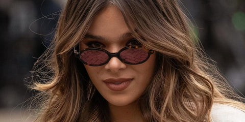 Hailee Steinfeld is seen wearing Miu Miu MU 04ZS VAU50D oval sunglasses to attend the brand's Fall/Winter 2024 fashion show in Paris