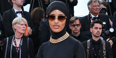 Halima Aden was seen weariing gold Cartier Panthere CT0399S 002 rimless sunglasses with brown gradient lenses at the 2023 Cannes Film Festival