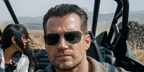 Henry Cavill was seen wearing gunmetal Ray-Ban Caravan Reverse RB R0102S 004/GR sunglasses with grey lenses in 2026 movie In The Grey.