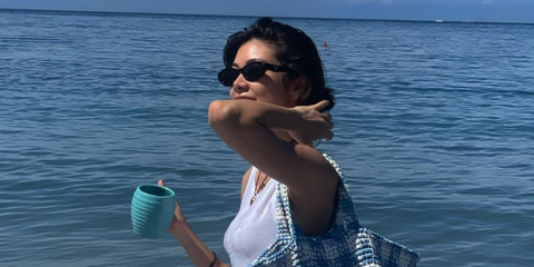 Japanese model and television personality Hikari Mori was seen wearing black Prada PR 26ZS 16K08Z cat eye sunglasses in her Instagram post, July 2023.