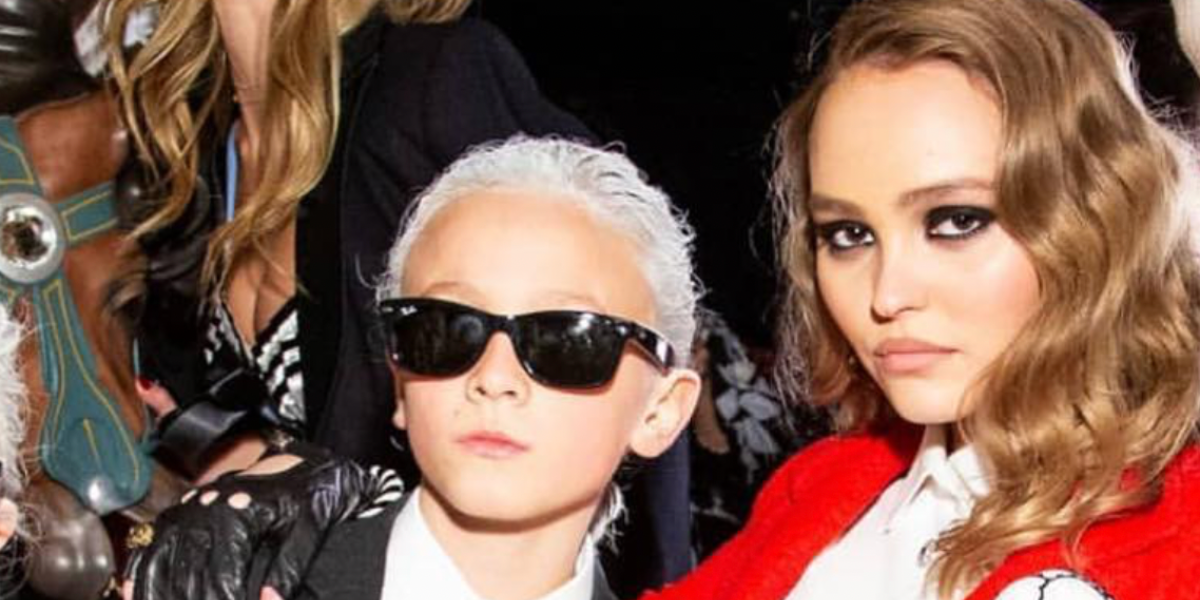 Child's model Hudson Kroenig, pictured with Lily-Rose Depp, was seen wearing black Ray-Ban Kids New Wayfarer RJ 9052S 100/71 Childs Frame sunglasses at the Chanel Spring/Summer 2019 fashion show during Paris Fashion Week. Shop online now on Pretavoir