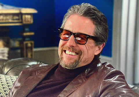 Hugh Grant was seen wearing black Ray-Ban Wayfarer RB 2140 1294/33 sunglasses with brown lenses in his movie The Gentlemen