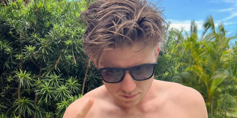 Track and field athlete Hunter Woodhall was seen wearing black Ray-Ban Chris 4187 622/8G sunglasses with grey gradient lenses in his Instagram post, October 2022,