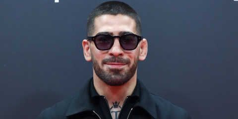 Spanish-Georgian mixed martial artist and UFC 2024 champion Ilia Topuria was seen wearing black Prada PR A16S 16K731 sunglasses at the Forbes Spain 30 Under 30 Festival in Madrid, September 2024.
