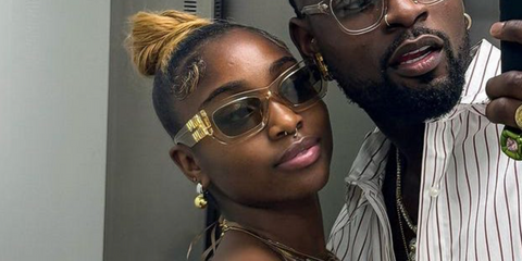 Television personality Indiyah Polack of Love Island (2022), pictured with ex boyfriend Dami Hope, was seen wearing transparent sand beige Miu Miu MU 09WS 11T40F sunglasses.