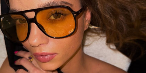 Model Inka Williams was seen wearing black Ray-Ban Bill RB 2198 901/R6 aviator sunglasses with yellow lenses at the Art Basel Qatar, February 2026.