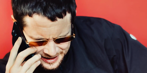 Actor Jack O'Connell was seen wearing gold Prada PR B54S 5AK50P sunglasses with brown lenses in The New York Times feature, January 2026.