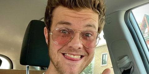 Jack Quaid was seen wearing gold Ray-Ban Aviator Large Metal RB 3025 001/5F Photochromic sunglasses