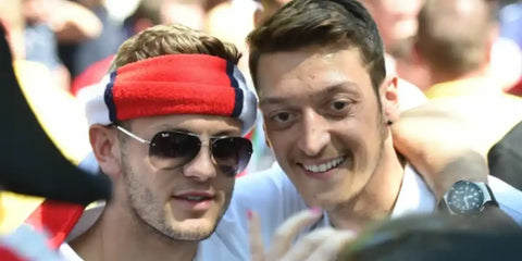 Jack Wilshere, pictured with Mesut Ozil, was seen wearing silver Ray-Ban RB 3449 003/8G aviator sunglasses with grey gradient lenses