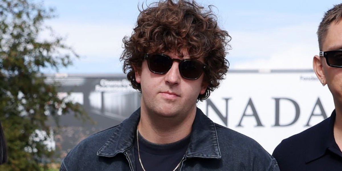 Producer, DJ, and musician Jamie xx was seen wearing black Prada PR A16S 16K731 sunglasses at the Prada Spring/Summer 2026 fashion show during Milan Fashion Week.