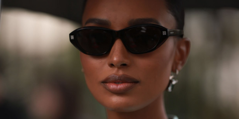 American model Jasmine Tookes wearing a full Givenchy look including black Givenchy oval sunglasses outside the Givenchy show during Paris Fashion Week 2022