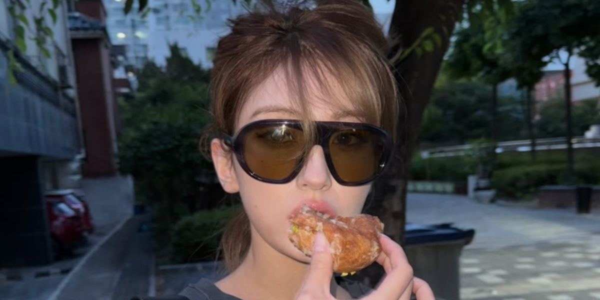 Canadian-South Korean singer Jeon Somi was seen wearing striped Prada PR C05S 23G70G sunglasses with green lenses in her Instagram post, June 2026.