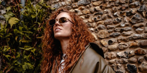 Jess Glynne was seen wearing gold Prada PR B53S 5AK09Z sunglasses in her Instagram post, September 2025.
