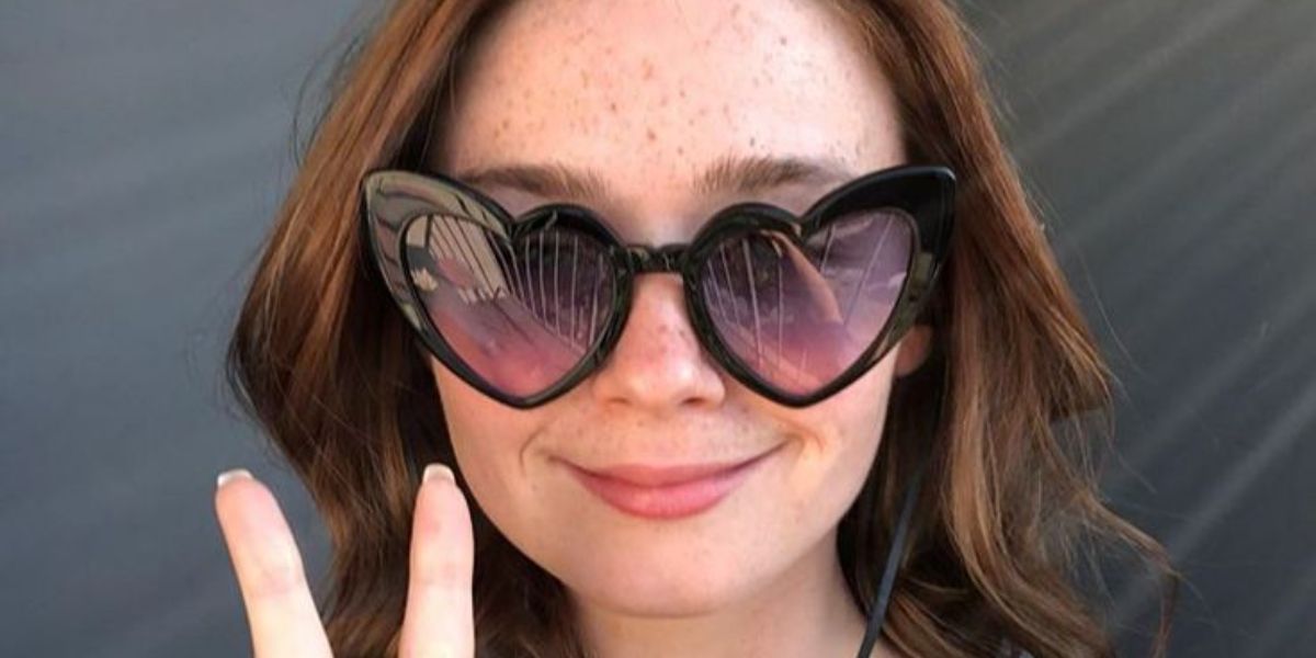 Jessica Barden was seen wearing black Saint Laurent Sun SL 181 LouLou 001 heart-shaped sunglasses