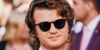 Joe Keery, also known as DJO, was seen wearing black Oliver Peoples N.02 Sun OV5529SU 1731/R5 round sunglasses to attend the 2024 Critic's Choice Movie Awards