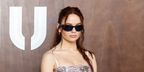 Joey King wore Miu Miu MU C06SU 22N51A wraparound sunglasses at the Miu Miu Spring Summer 2027 show during Paris Fashion Week.