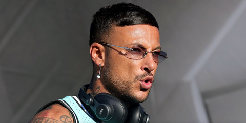 French DJ and producer Joezi was seen wearing Miu Miu MU A54S 5AK04O rimless oval sunglasses onstage at the Coachella Music Festival 2026.