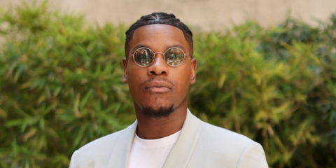 John Boyega wears Giorgio Armani AR6115T 3002/2 round sunglasses to the brand's Spring/Summer 2024 fashion show in Milan