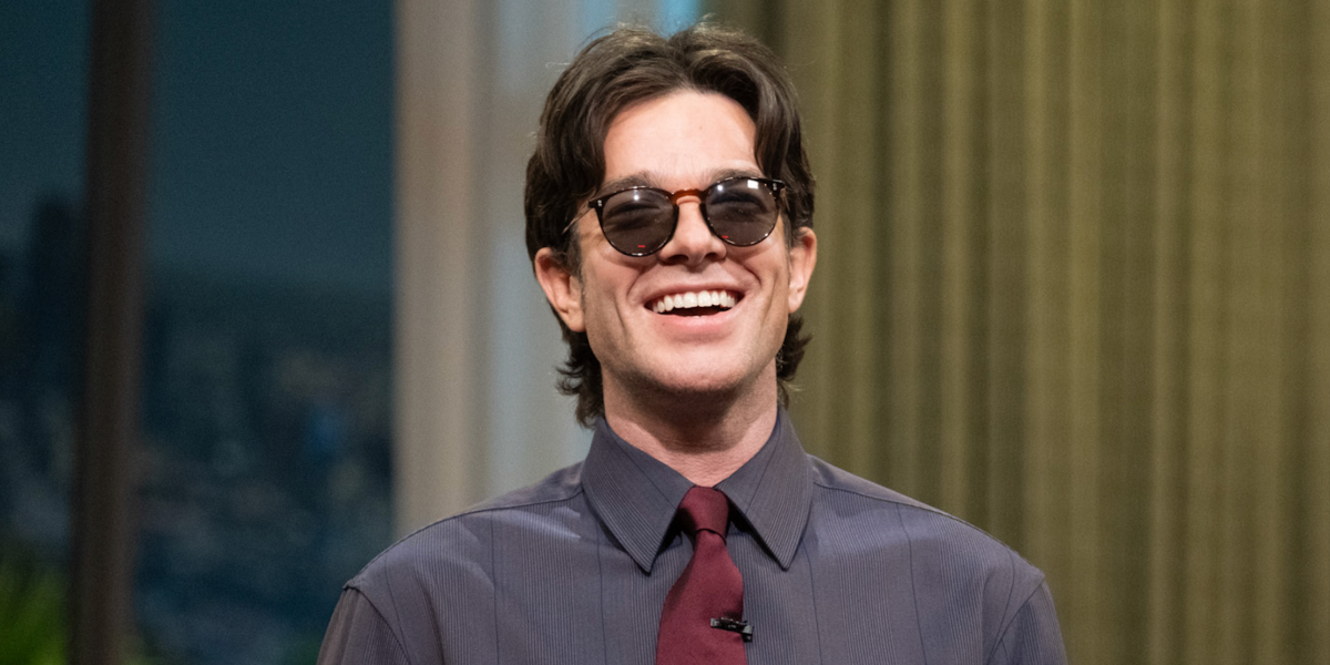 John Mulaney is seen wearing Oliver Peoples O'Malley Sun OV5183S 1005/P1 Black Polarised round sunglasses