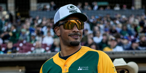 American football player Jordan Love of Green Bay Packers was seen wearing black Oakley Sutro Lite OO9463 13 sunglasses with 24k Prizm lenses during the Green Bay Charity Softball Game in May 2025.