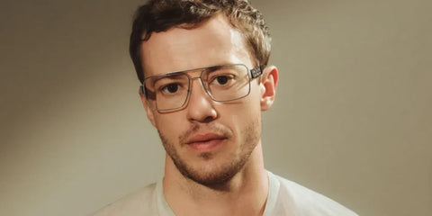 Joseph Quinn was seen wearing gunmetal Versace 1308 1000 optical glasses in the Versace Greca Eyewear campaign, October 2025.
