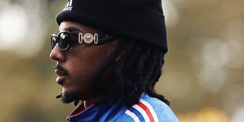 Jules Kounde was seen wearing the iconic black Versace 4361 GB1/87 Medusa Biggie Sunglasses while wearing the French national football team uniform
