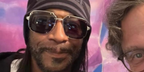 Comedian Katt Williams is seen wearing studded Cartier CT0194S 001 silver aviator sunglasses while being photographed with a fan
