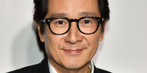 Ke Huy Quan was seen wearing black Oliver Peoples Sheldrake OV5036 1492 square optical glasses to the premiere of Everything Everywhere All At Once in Los Angeles