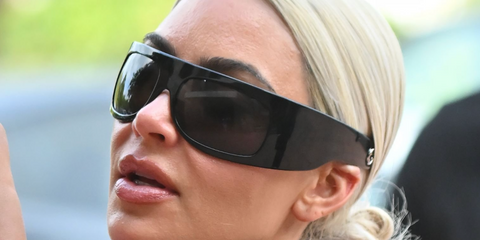 Kim Kardashian in May 2024 arriving at her son's basketball game wearing black Gucci wrap-around shield sunglasses.