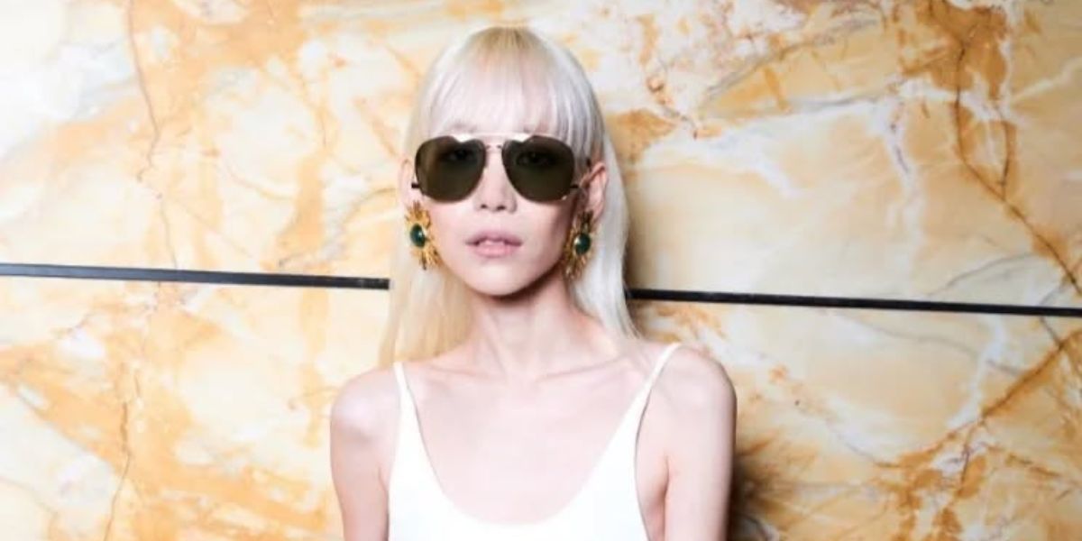 Kitty Chicha Amatayakul is seen wearing Saint Laurent Sun SL 653 Leon 001 to the brand's Spring/Summer 2024 in Paris