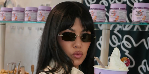 Kourtney Kardashian was seen wearing gold Miu Miu MU B50S 26C09Z sunglasses with dark brown lenses in Lemme Skin x Mimi's Frozen Yogurt collaboration activation, shared through her Instagram post in July 2026.
